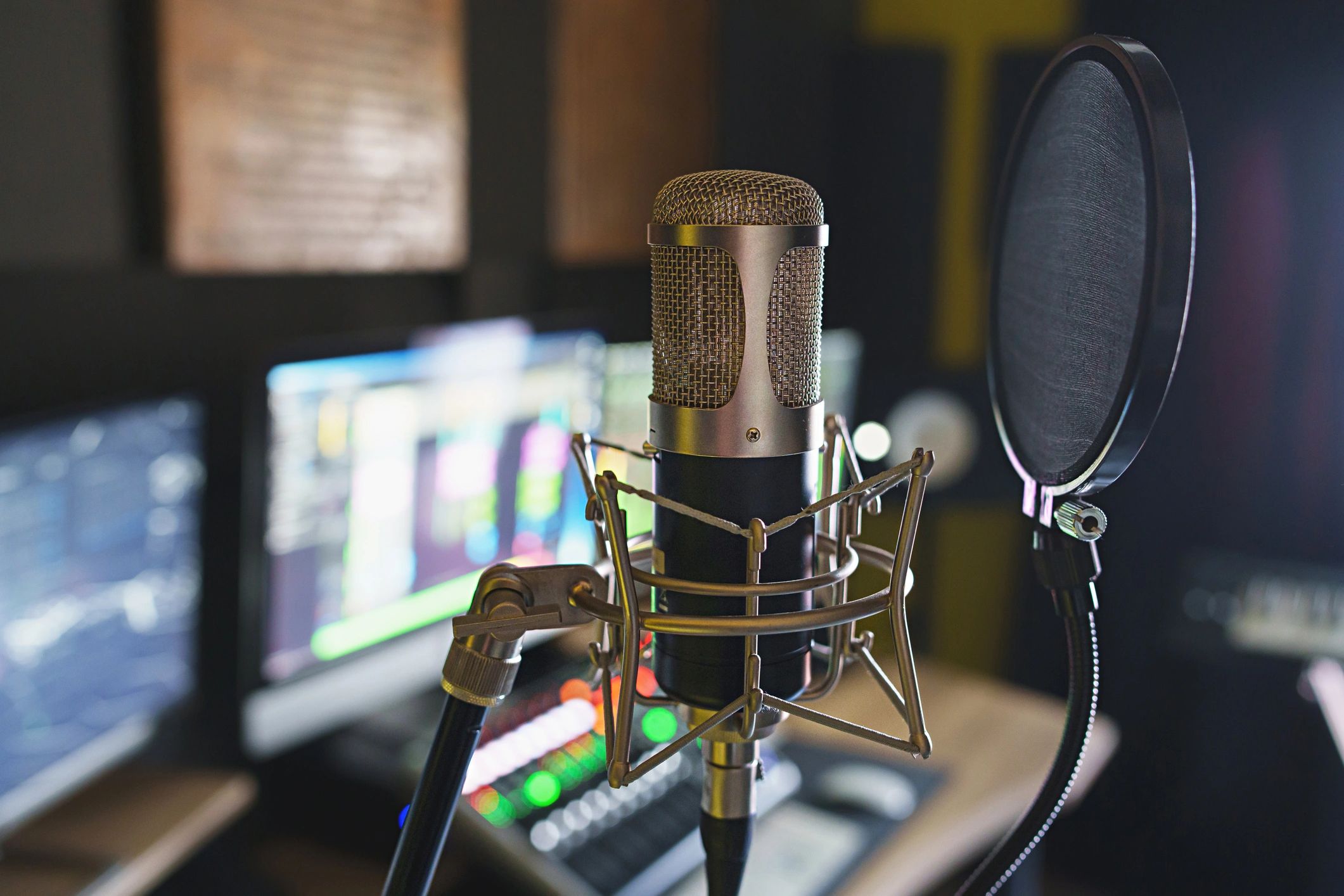 Close-up of microphone with studio mixer in background