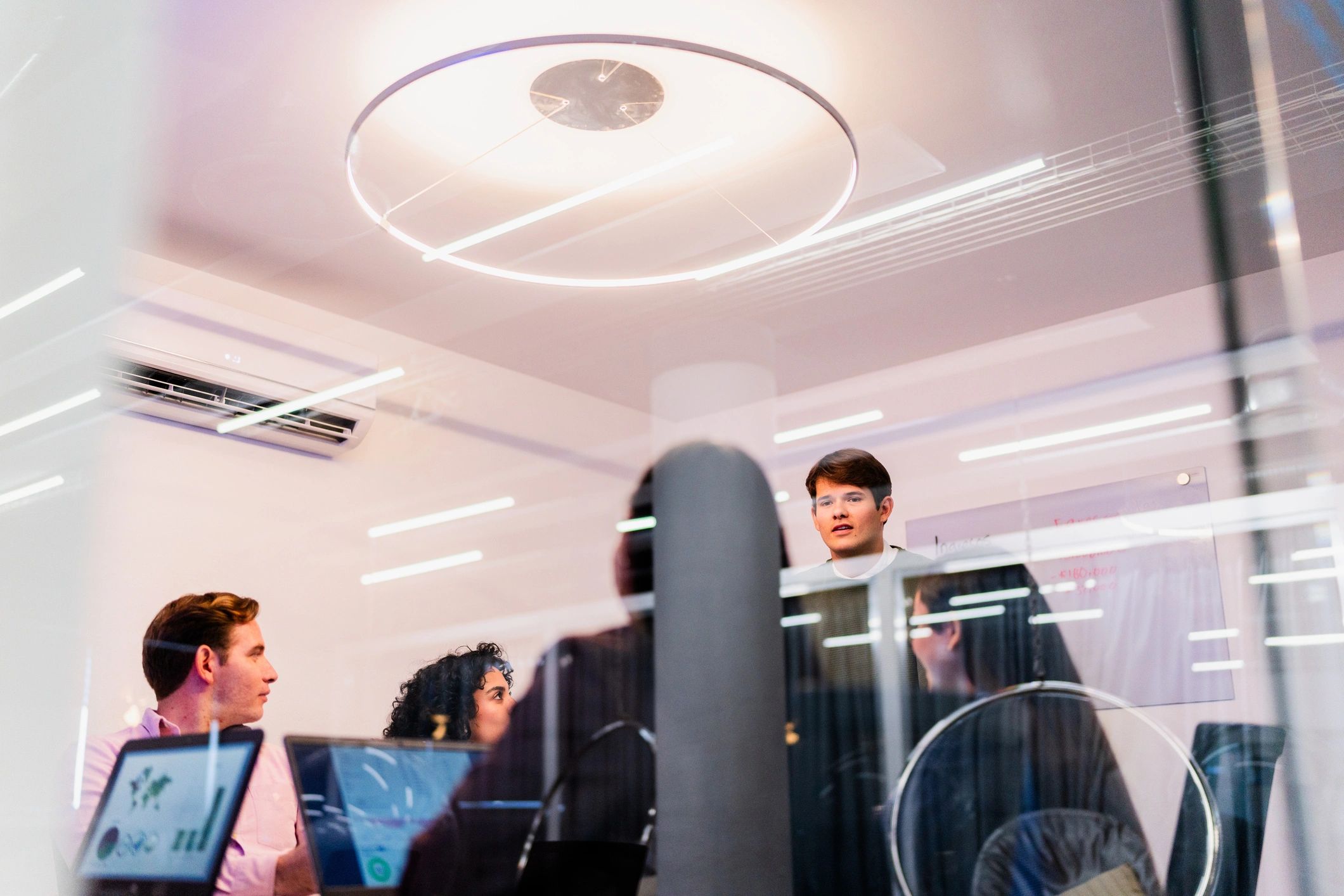 Technicians discussing an AV installation plan during an office meeting