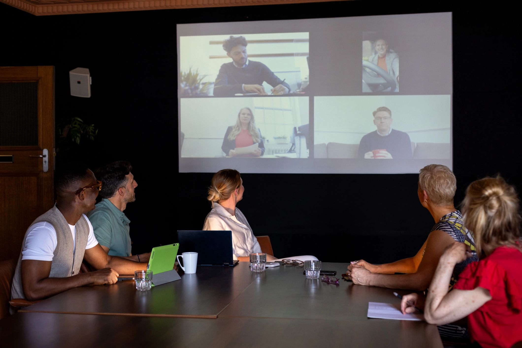 Team collaborating in a modern boardroom during a hybrid meeting