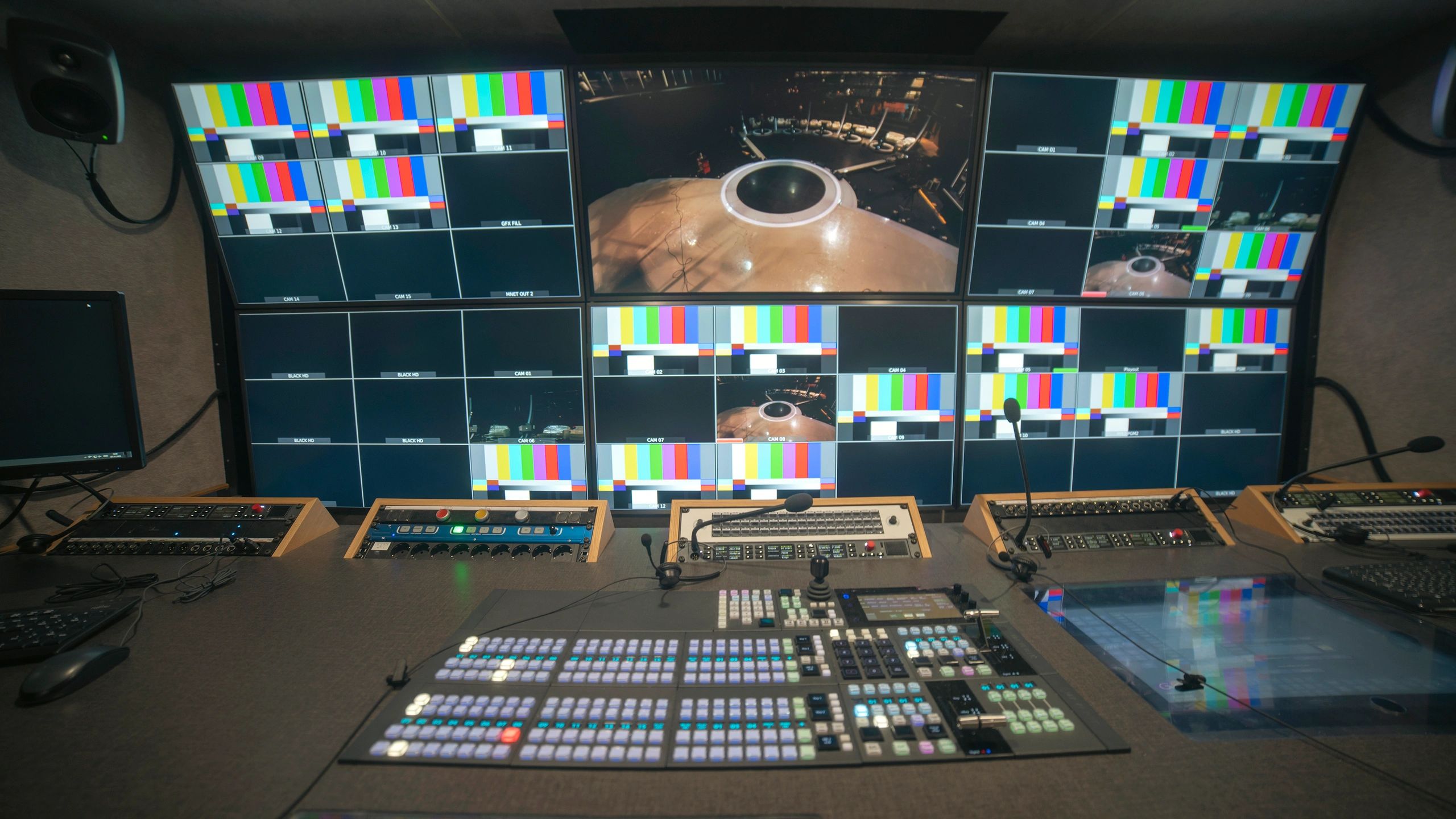 Professional broadcast control room with multiview monitors and video switcher console